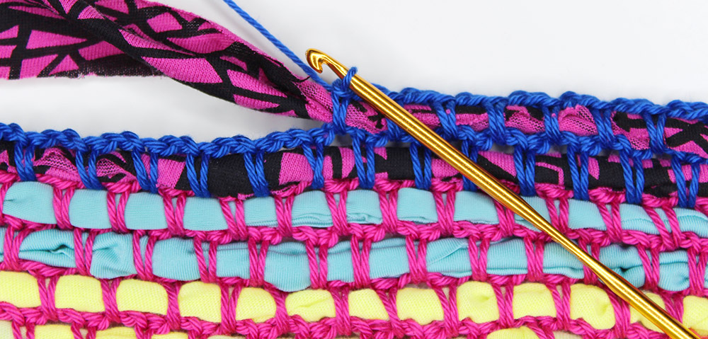 Close-up photo crocheting t-shirt yarn into a rug - Knit & Crochet